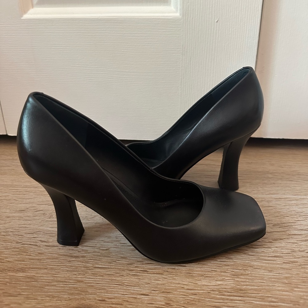 Black leather pumps